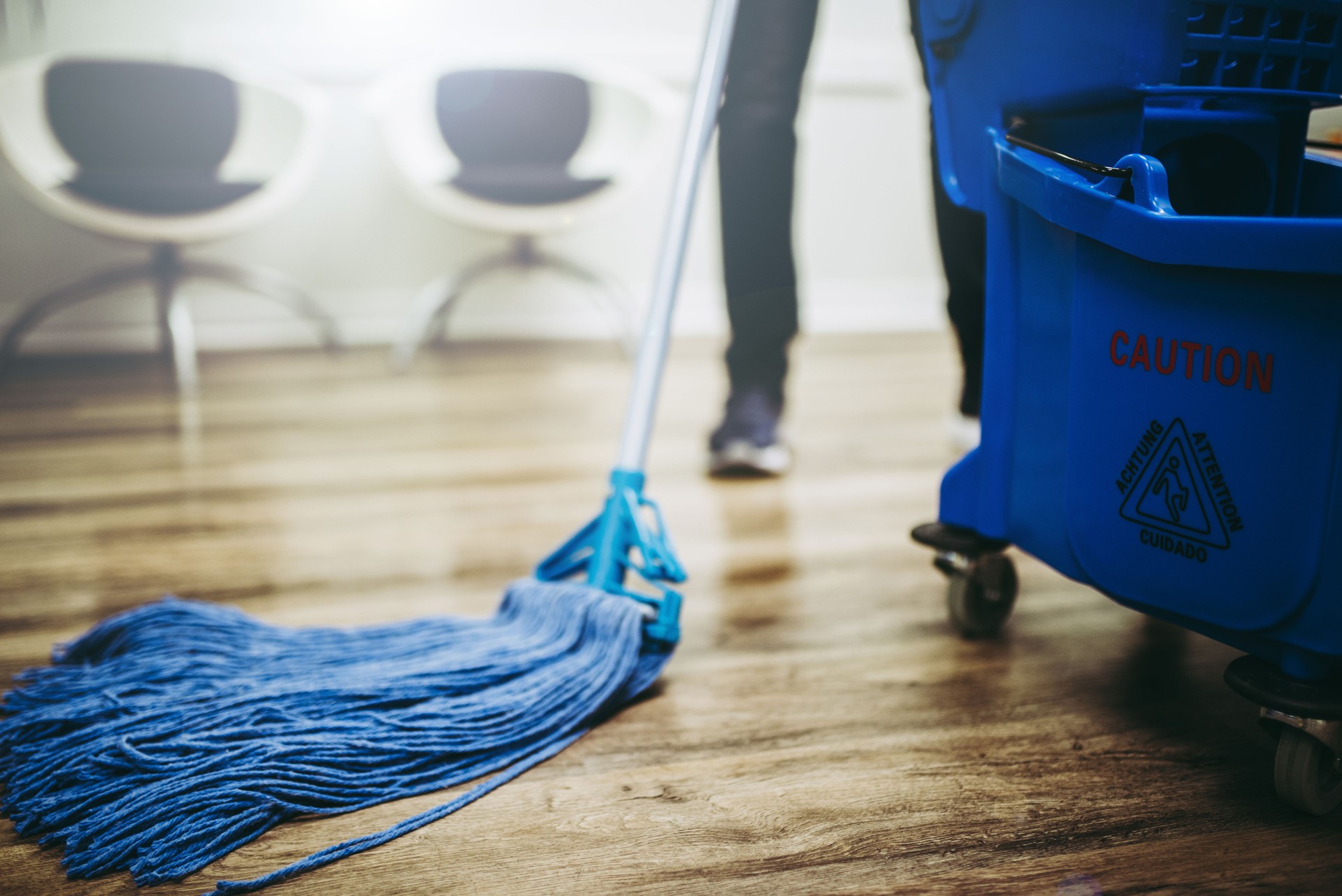 Janitor cleaning the floor inside an office building.
